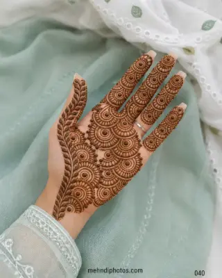 Full front hand mehndi design featuring layered semicircular patterns across the palm and fingers with a long leafy border