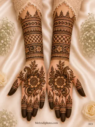 Full hand bridal mehndi design on both palms and forearms featuring large flowers, paisley motifs, leafy details, diamond jaali bands and shaded fingertips.