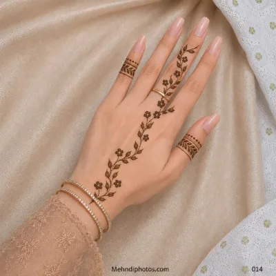 Back hand with a diagonal vine of small flowers and leaves, plus matching leafy mehndi bands on the thumb and little finger.