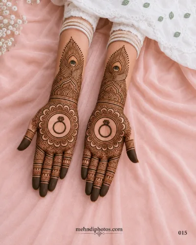 Engagement full hand mehndi design featuring matching ring motifs, peacock feather patterns and intricate floral details on both palms.