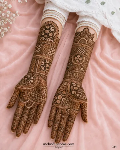 Full hand bridal mehndi design on both palms featuring intricate floral patterns, check motifs, and detailed forearm henna artwork