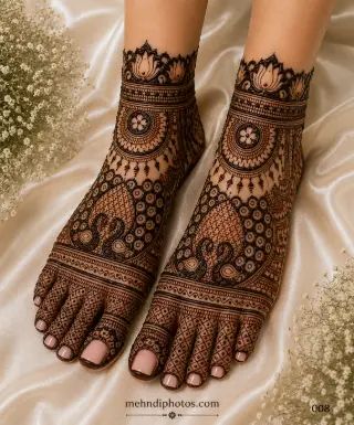 Traditional full foot mehndi design with paisley motifs, floral circles, decorative ankle bands, and intricate toe patterns for brides and festive occasions.