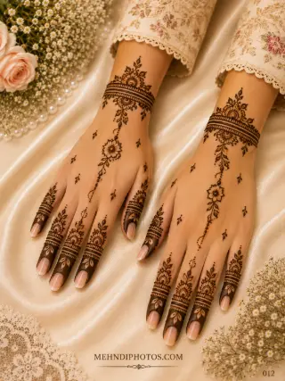 Minimal back hand mehndi design on two hands with floral wrist bracelets, central hanging flower vines, scattered leaves and shaded finger patterns.