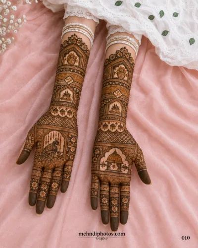 Detailed bridal full hand mehndi design featuring peacock, floral, arch and traditional patterns on both palms.
