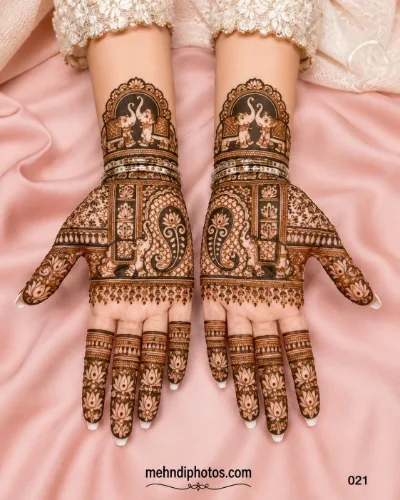 Engagement full hand mehndi design featuring matching elephant motifs, floral patterns, paisley details and intricate traditional artwork.