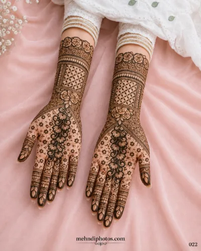 Elegant floral bridal mehndi design with detailed wrist bands and delicate patterns on both hands.
