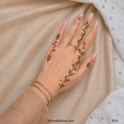 Back hand with minimal leafy mehndi vines, crescent moon motifs, tiny stars and small geometric finger details.