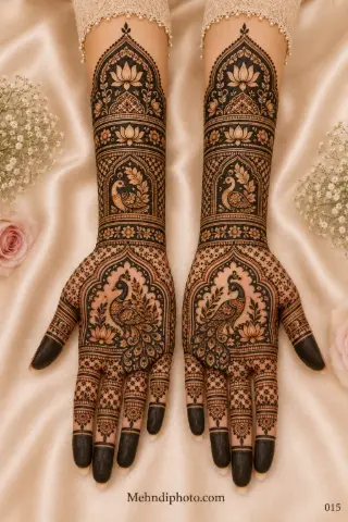 Full hand bridal mehndi design on both palms and forearms featuring royal peacocks, lotus motifs, arch panels, jaali patterns and dark fingertips.