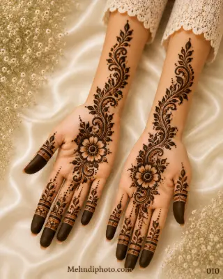Simple bridal front hand mehndi design with floral vines, leafy details and full-hand Indian henna extending to the forearms.